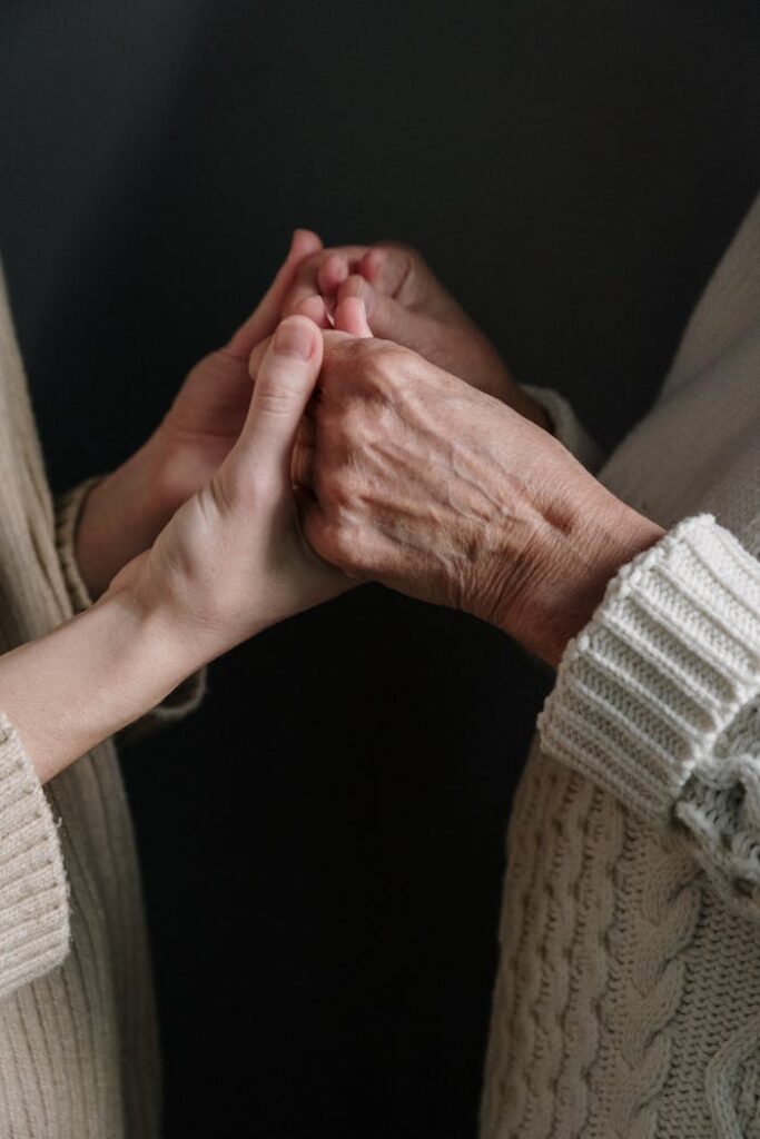 pexels photo 5493781 Two generations connect through holding hands, symbolizing love and unity.